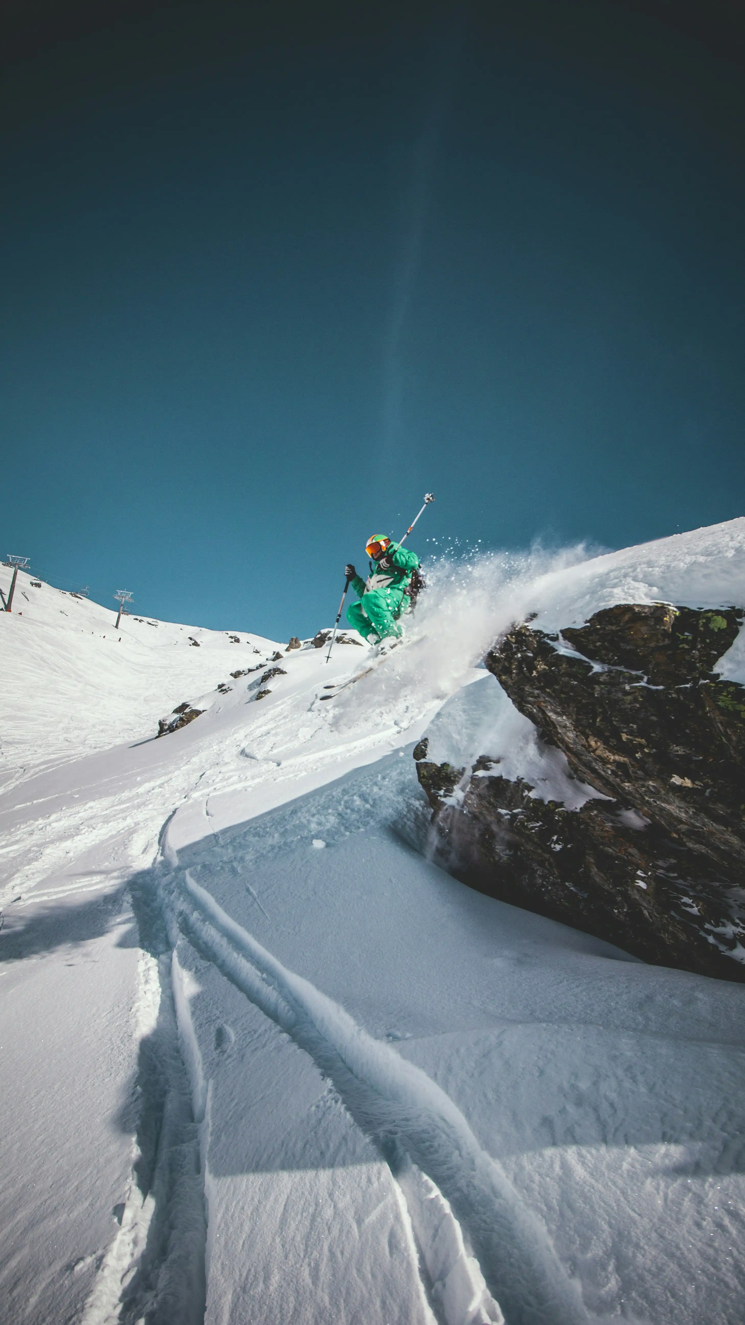 skier jumping off rock
